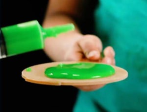 Picture of green slime on paddle for virtual field trip for Fun Friday Ideas.