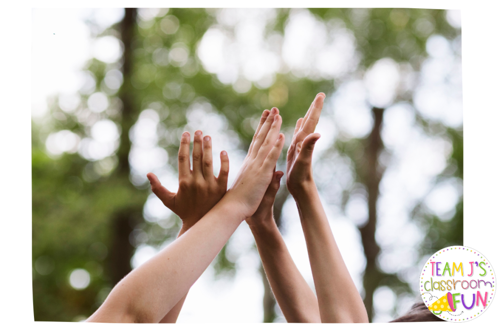 Photo of 4 kids giving a high 5