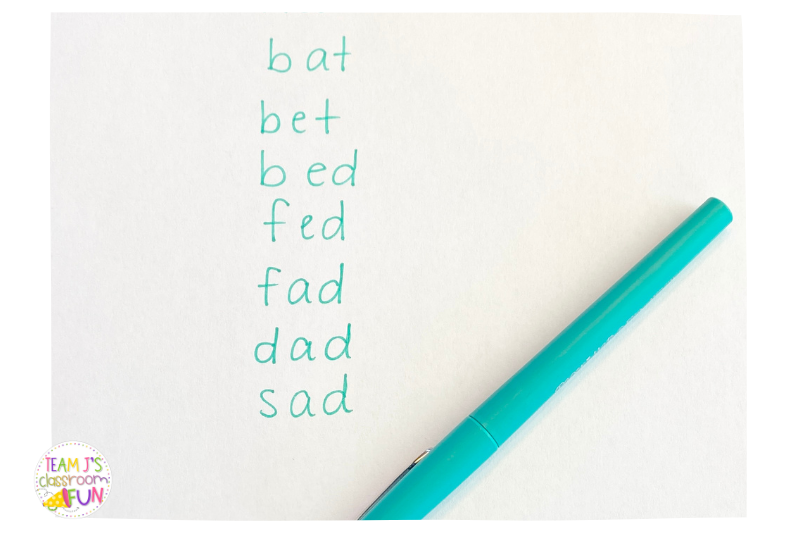 Photo of word ladder activity with a blue pen - words written in a vertical line are bat, bet, bed, fed, fad, dad, sad