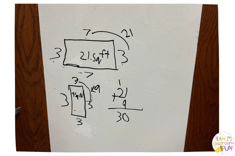 photo of adhesive white board roll on a classroom door with a math problem solved on it